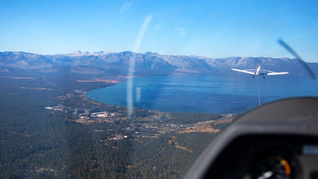 a soaring nevada glider being towed in the sky over lake tahoe