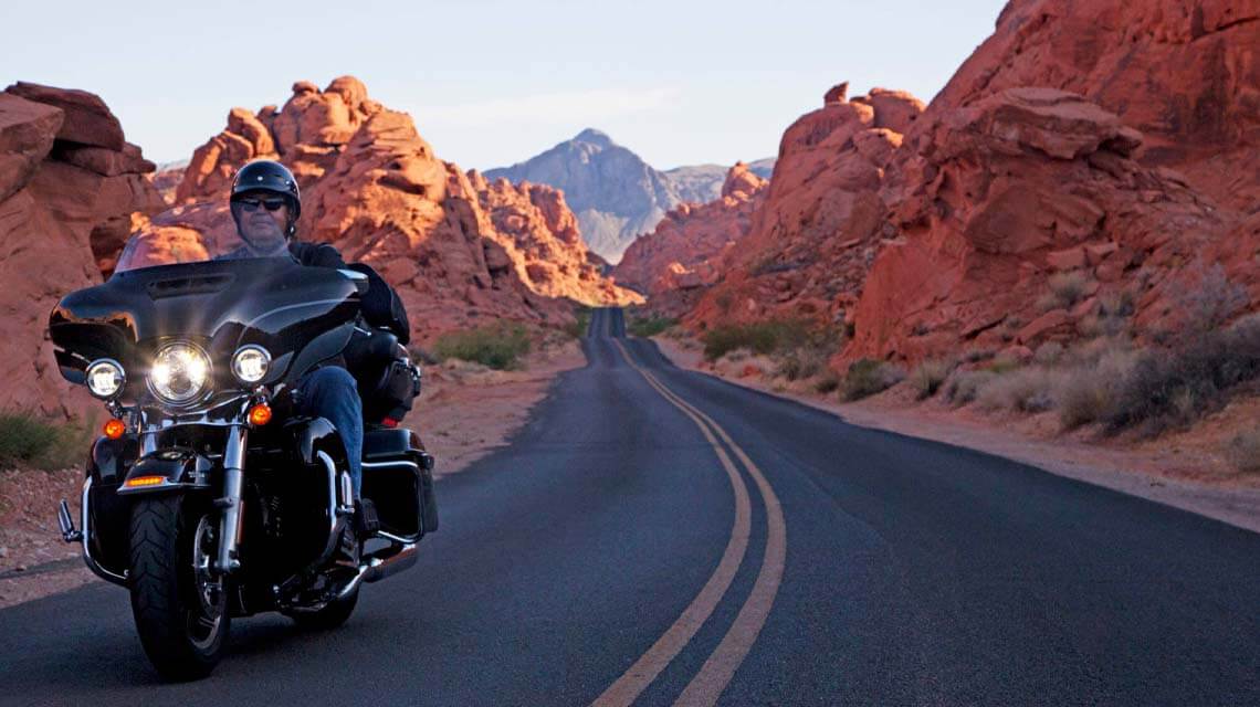 motorcyclist driving through valley of fire state park