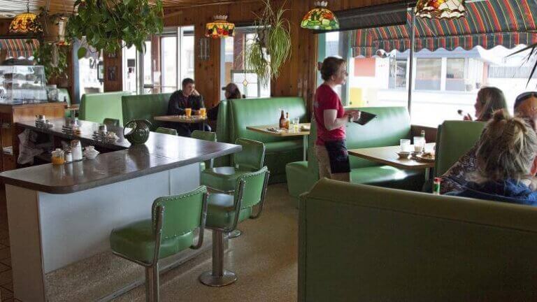 waiter at the griddle serving customers