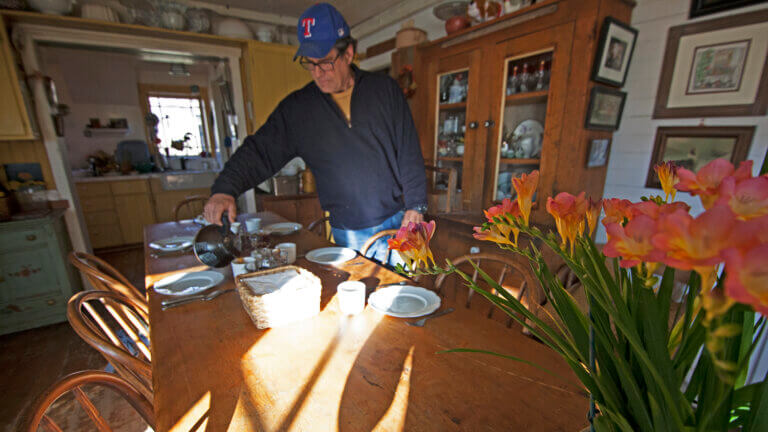 man pouring coffee at the dinner table