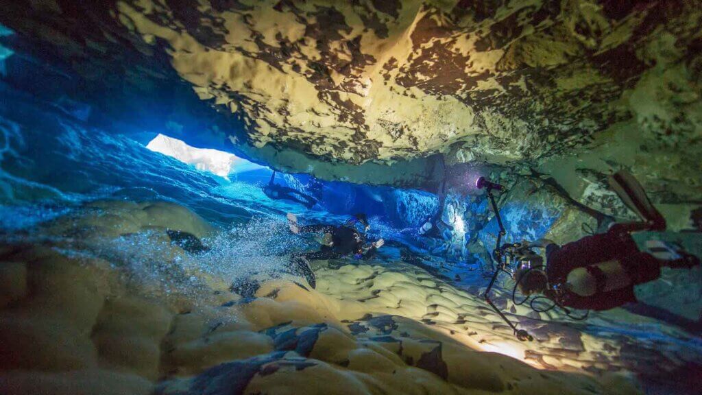 divers underwater in devils hole