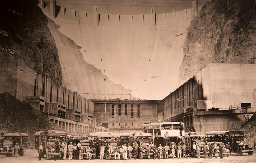 historic image of workers gathered in front of the hoover dam