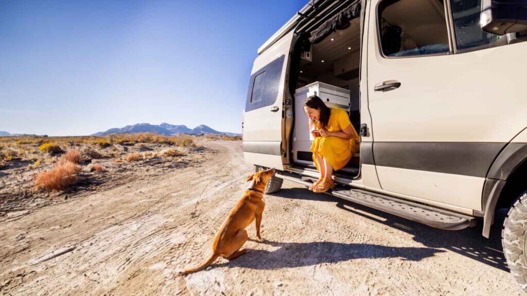 woman and dog by camper van