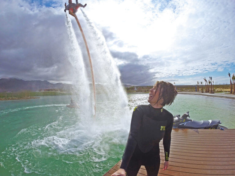 person watching someone ride a water jet pack