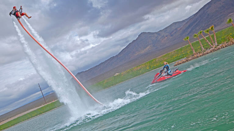 water jet pack rider and jet ski observing