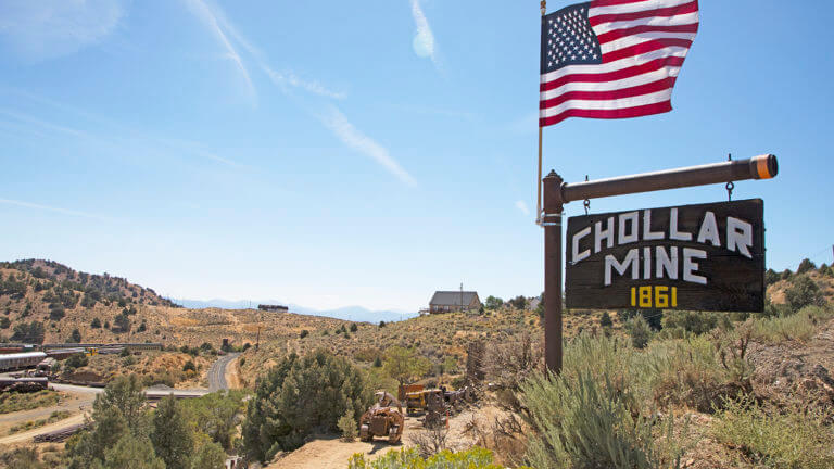 american flag and chollar mine sign