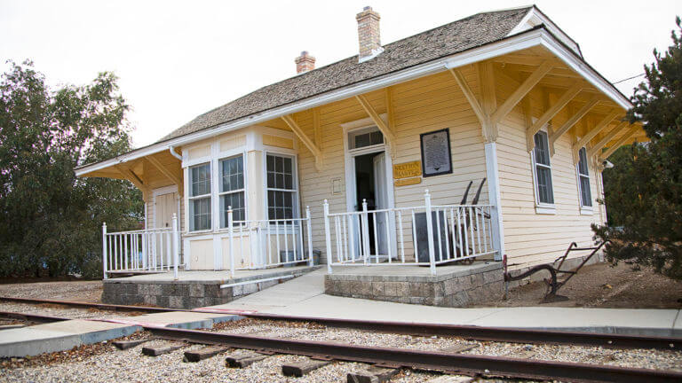 white pine public musuem in front of railroad