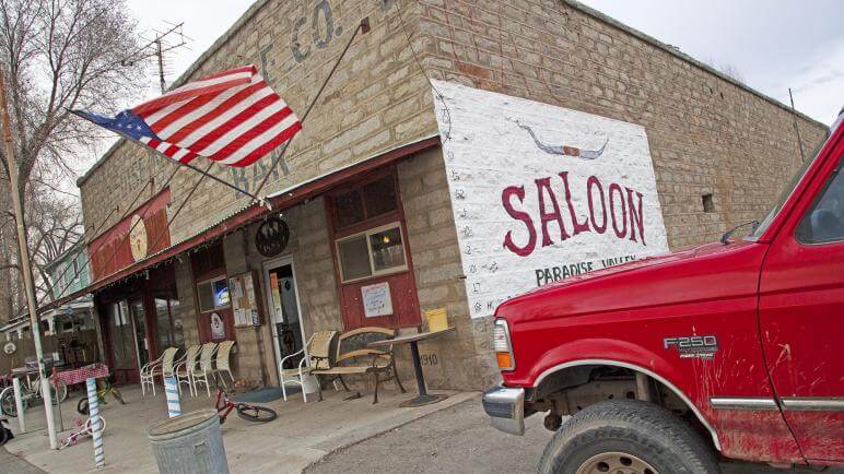 red truck parked in front of the paradise valley saloon and bar g