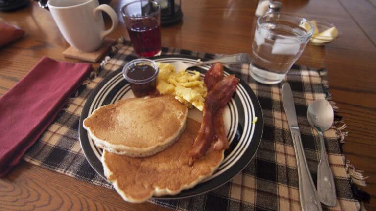 breakfast plate of bacon eggs and pancakes at the pine tree inn and bakery