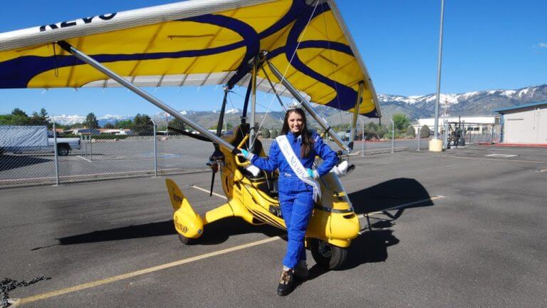 woman posing in front of hang glider