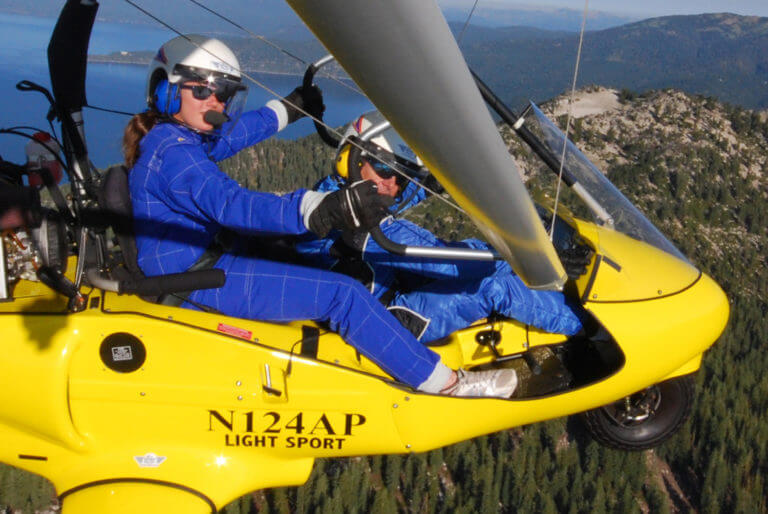 couple in hang glider looking at the camera