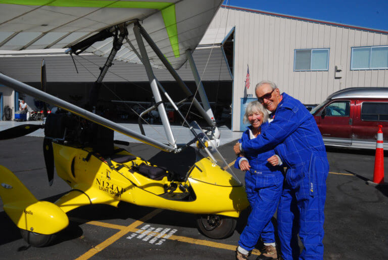 couple posing for camera after tahoe hang glider ride