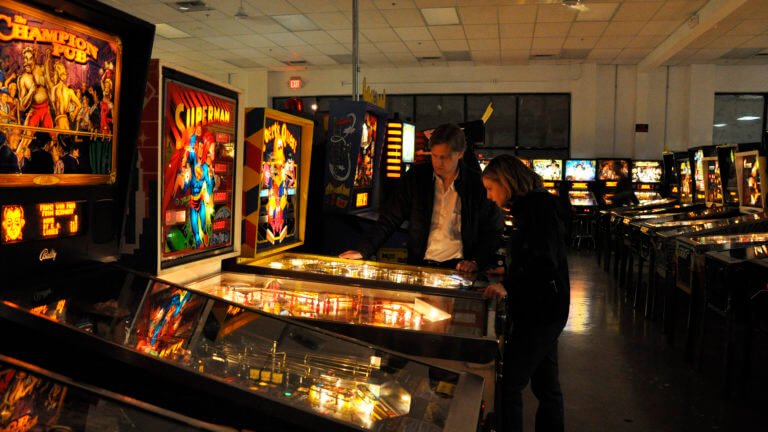 people playing pinball at the pinball hall of fame