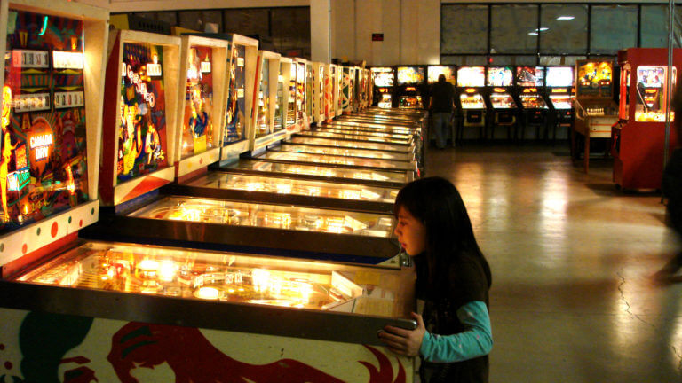 child playing pinball