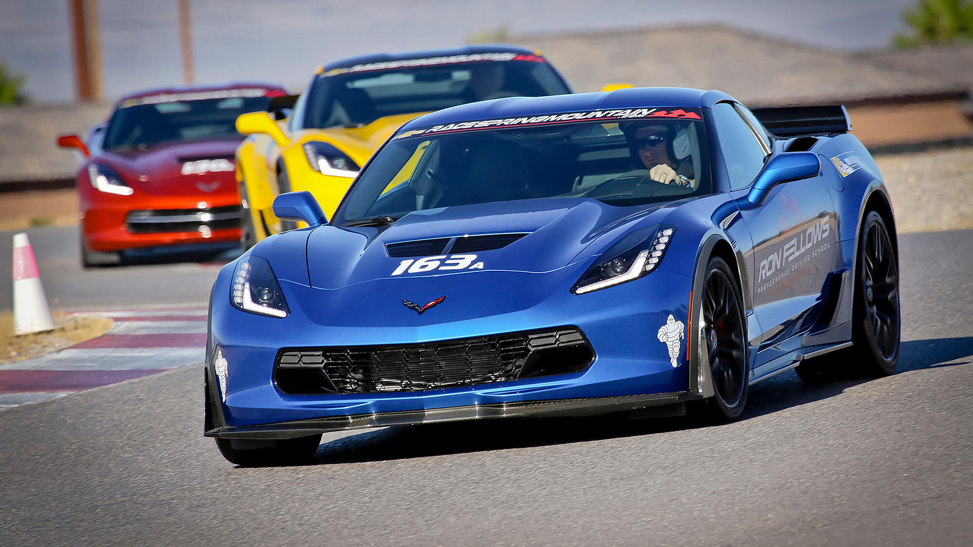 three corvettes race on a track