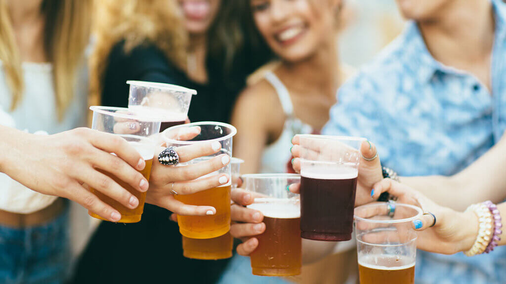 friends cheersing beers at a beer festival