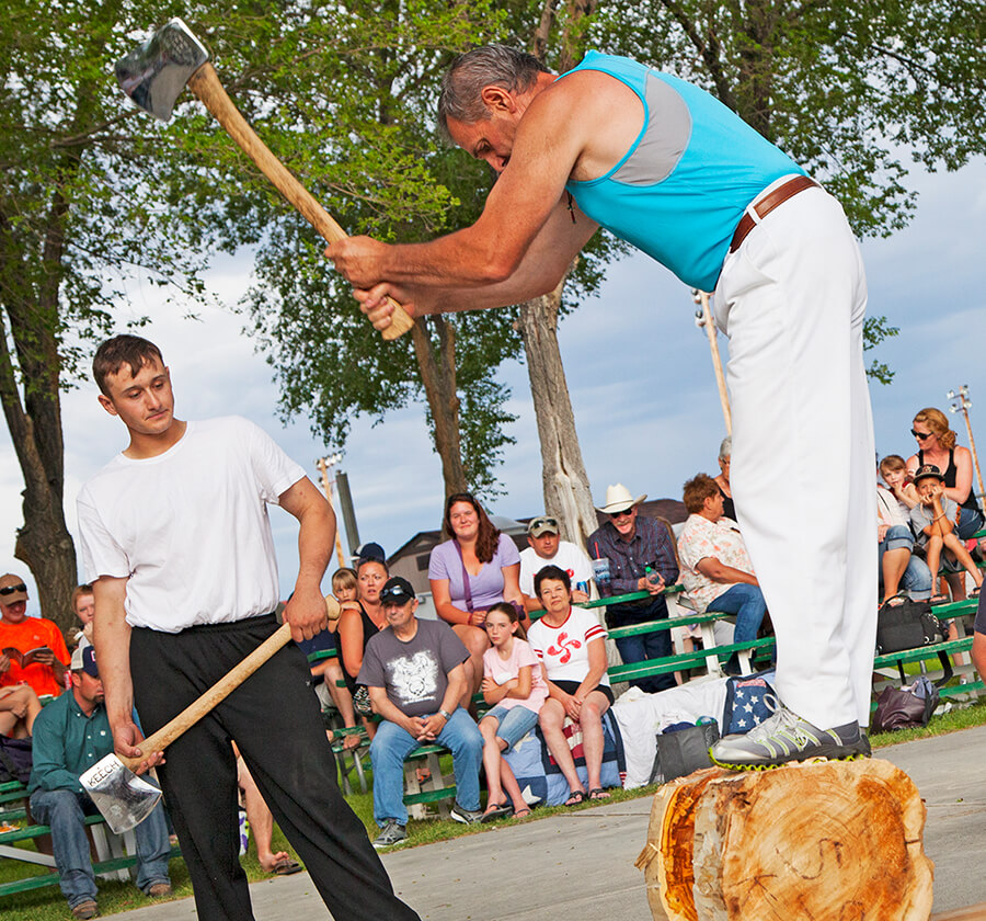 two men chopping wood at the national basque festival