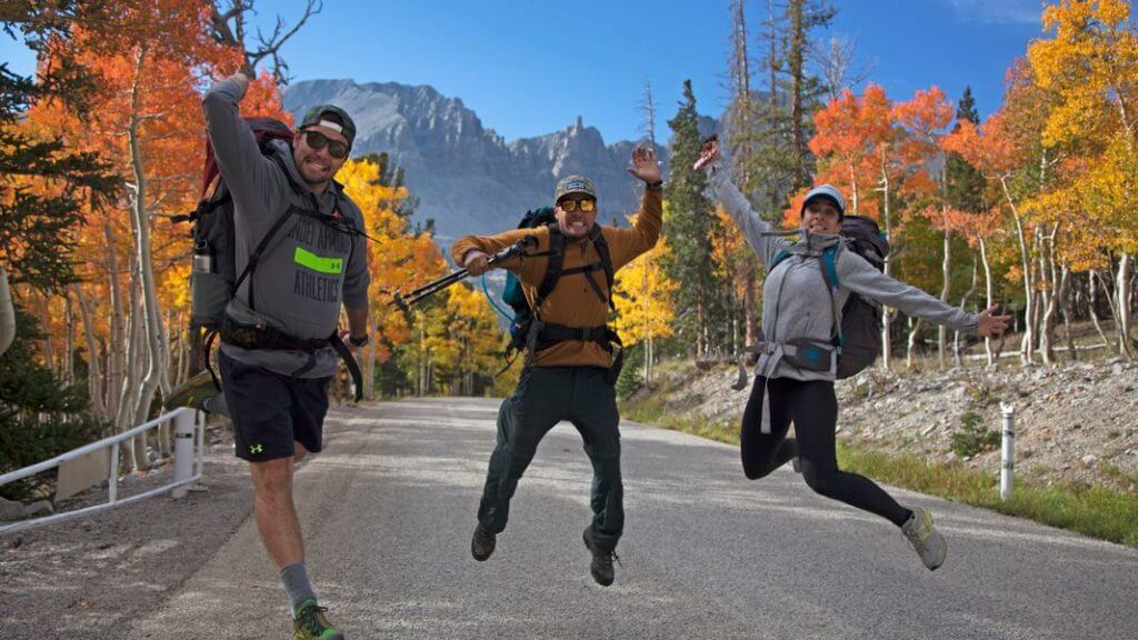 people jumping in middle of the road