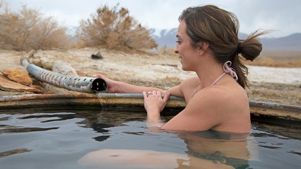 woman fixing a valve in a hot spring