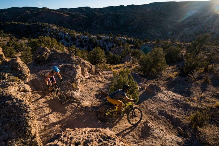 two people mountain biking