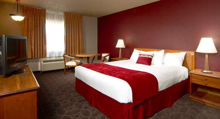 single bed with red accents in a room at the edgewater casino resort