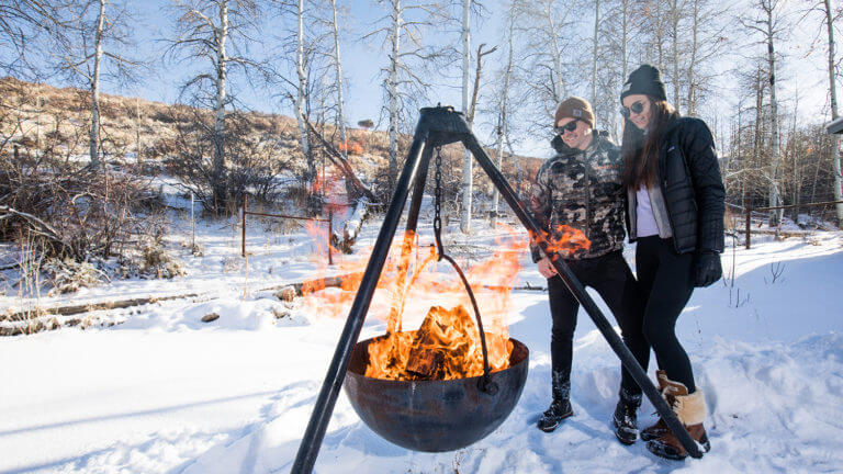 keeping warm in front of the outdoor firepit