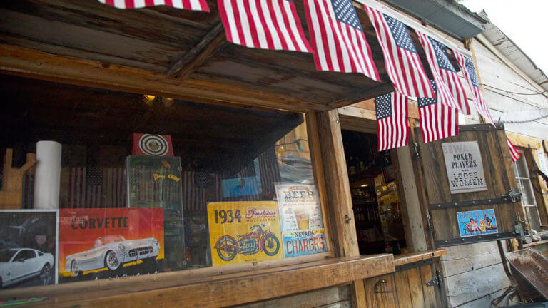 window decorated with pictures of classic cars and small american flags hanging over top