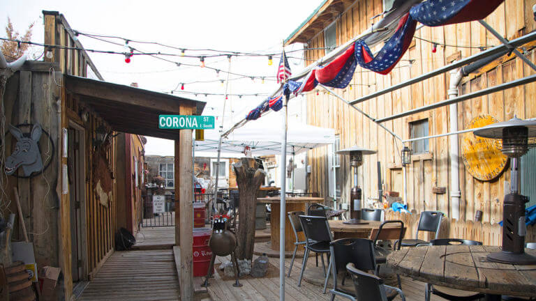 outdoor dining area at happy burro with a heat lamp and corona street sign