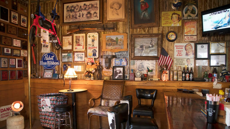 wall decorated with all sorts of memorabilia at the happy burro