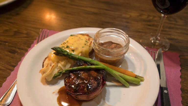 steak with potato and veggies at cellblock steakhouse