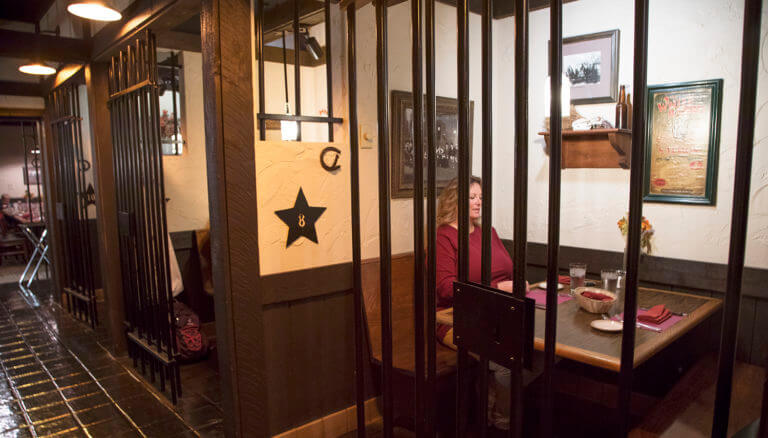 woman eats behind bars at cellblock steakhouse