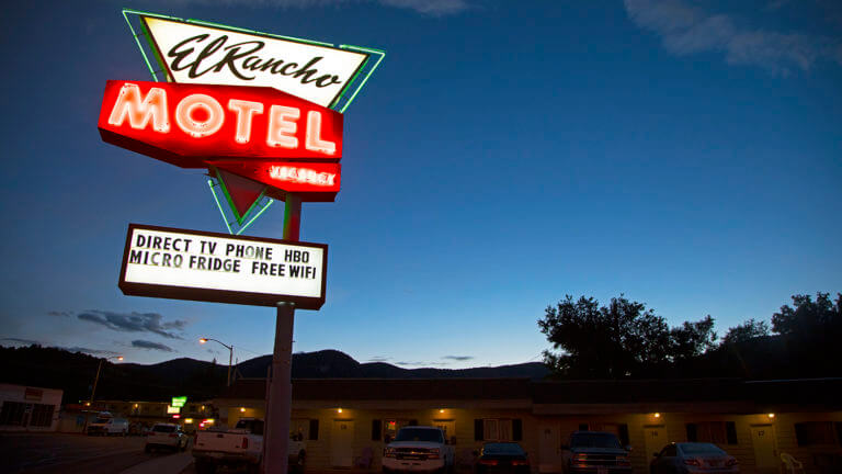 el rancho motel neon sign at night