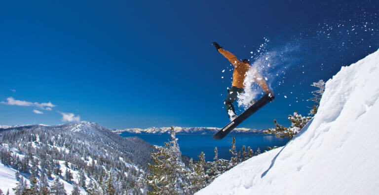 skier jumping a ridge in north tahoe