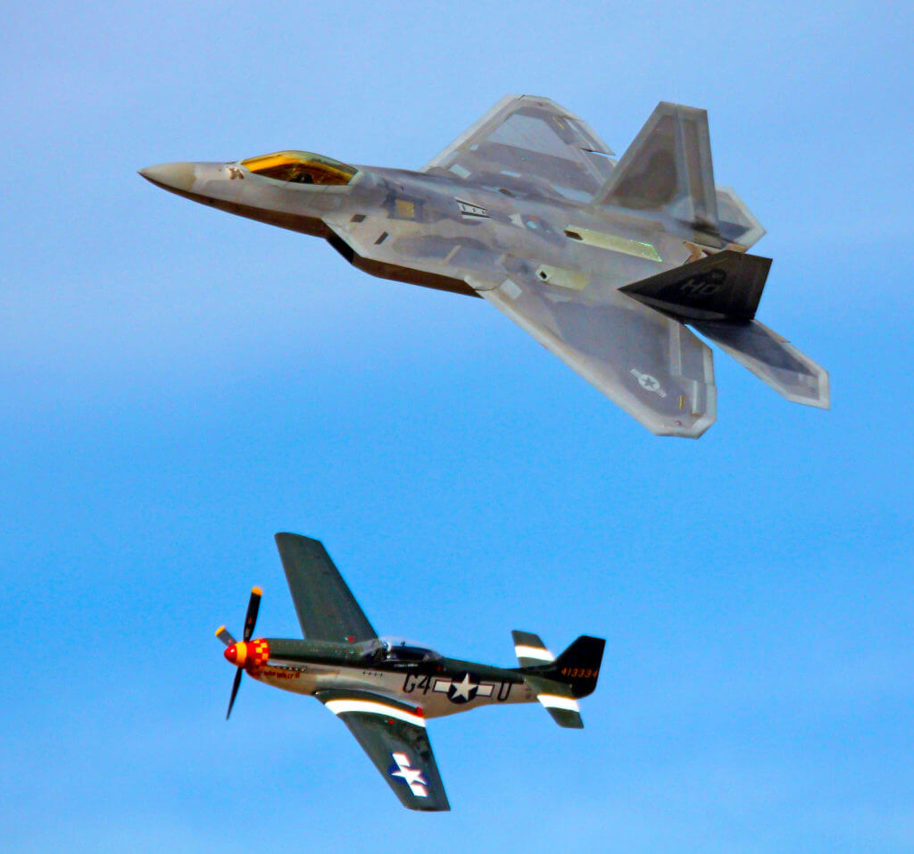 a fighter jet and prop plane flying at the reno air races