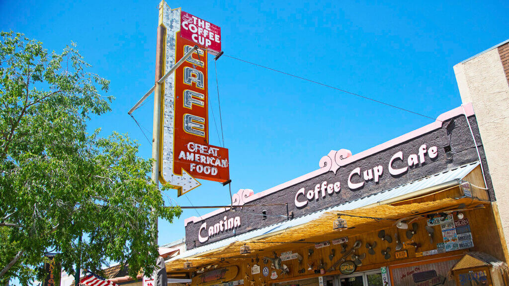 neon arrow sign at the coffee cup cafe