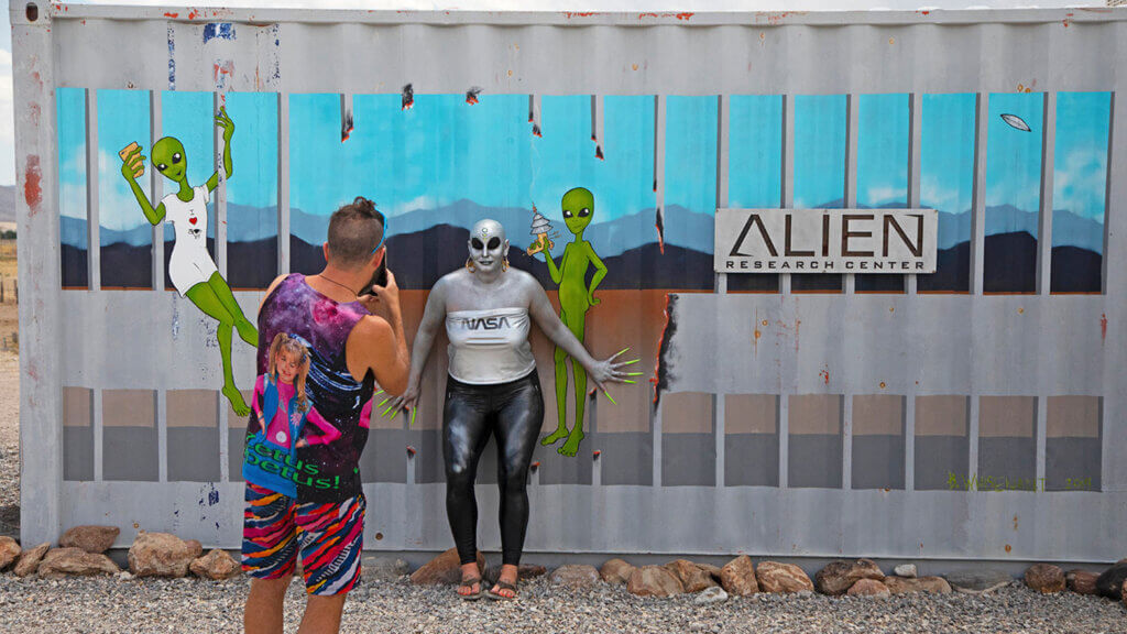 two people in costume outside the alien research center near area 51