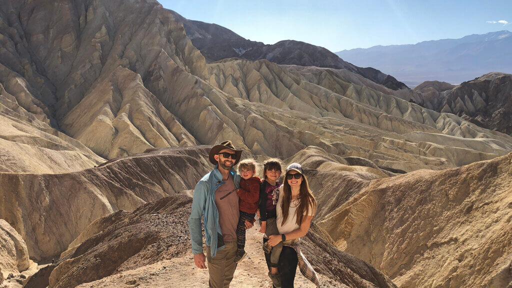 a family of hikers at zabriskie point in death valley