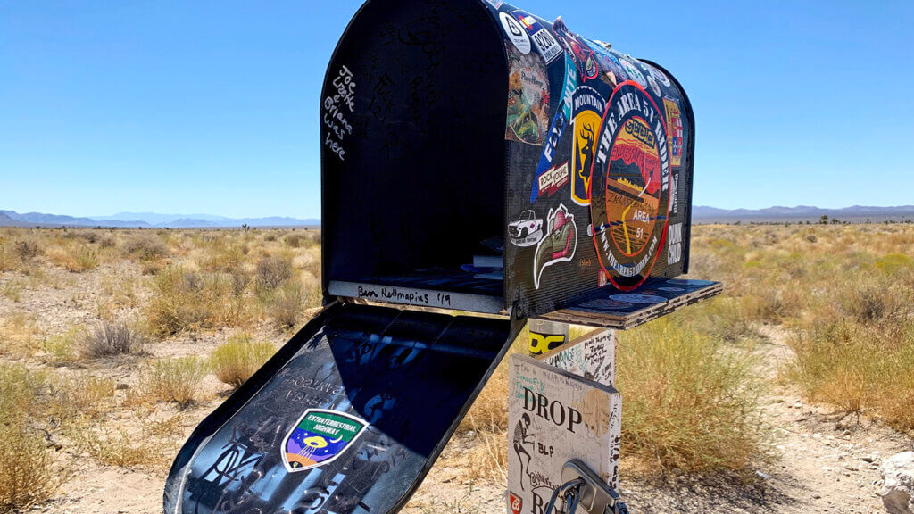 black mailbox open in the desert
