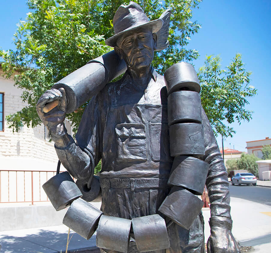 statue of a man with toilet paper rolls draped over him
