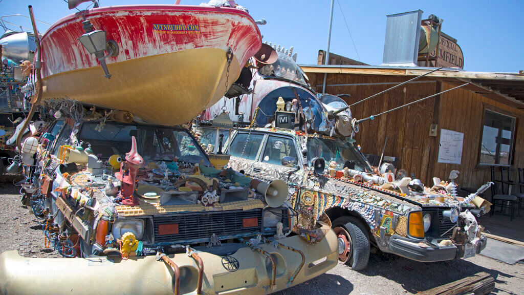 cars and boat covered in art