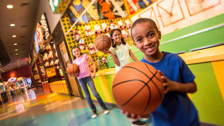 boy holding basketball at the circus circus midway