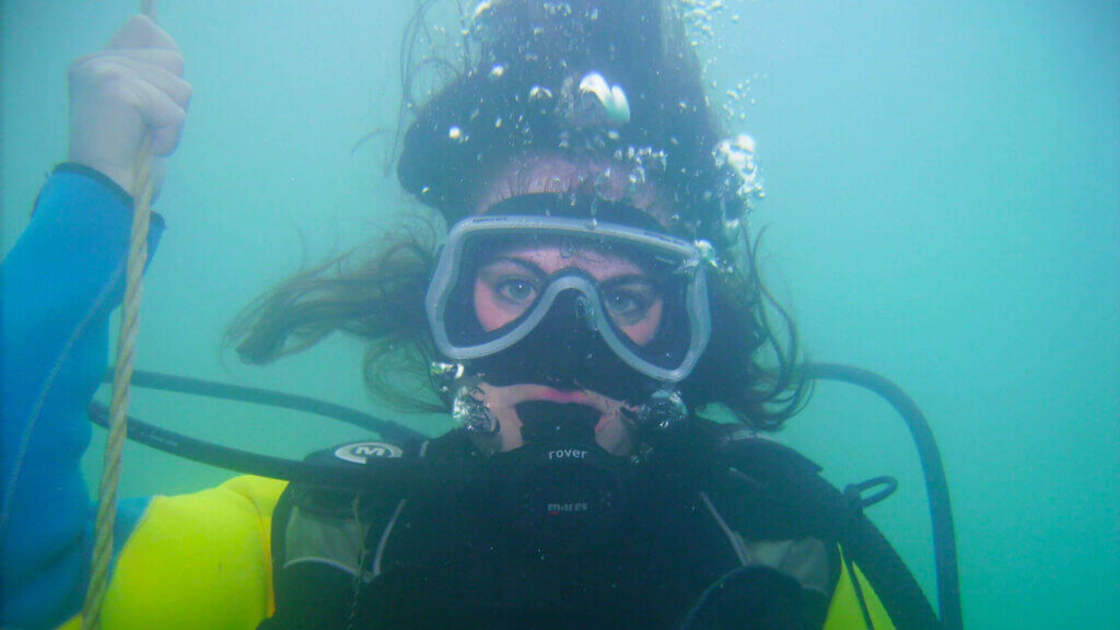 woman scuba diving at blue lake