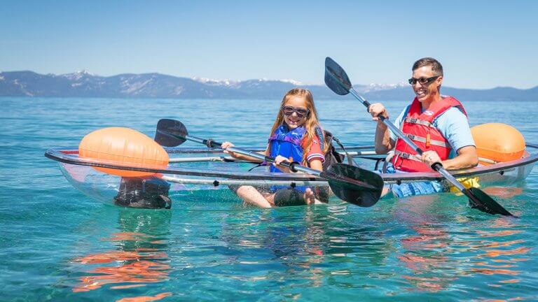 two people in a clear kayak on lake tahoe