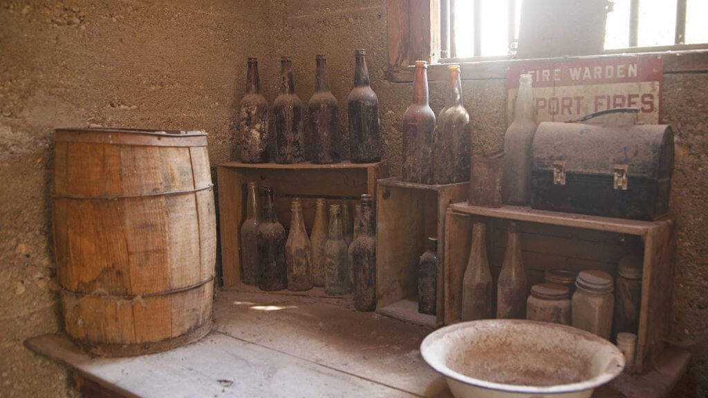 bottles and barrel on a table at historic jarbidge jail