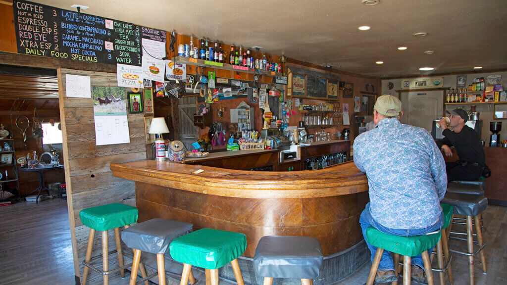 guests at bar top of the miners club