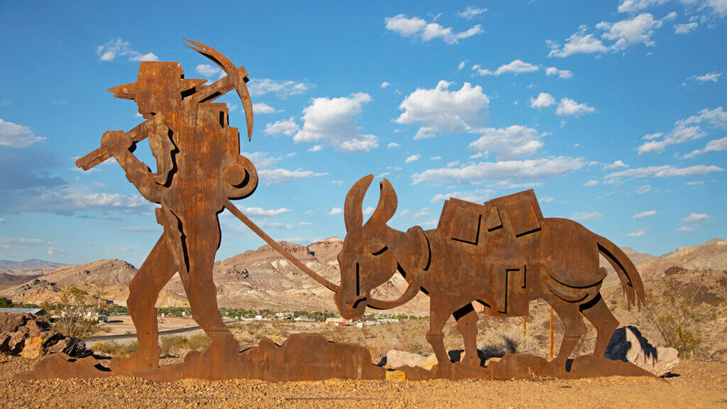 statue of a miner and his burro near beatty