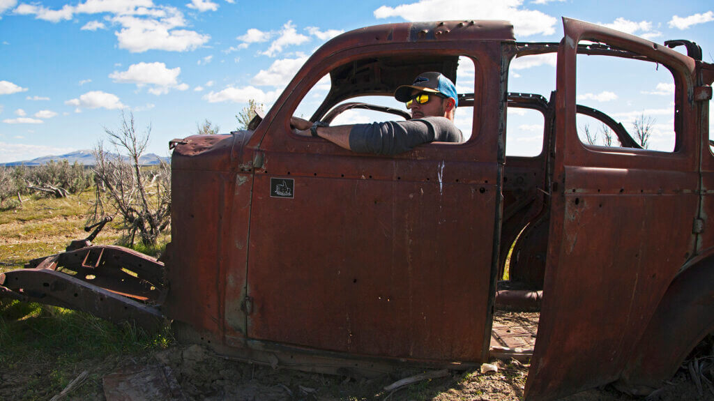 man in torn down car