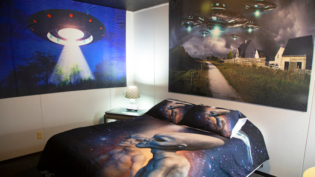 bedroom with alien posters and bed sheets