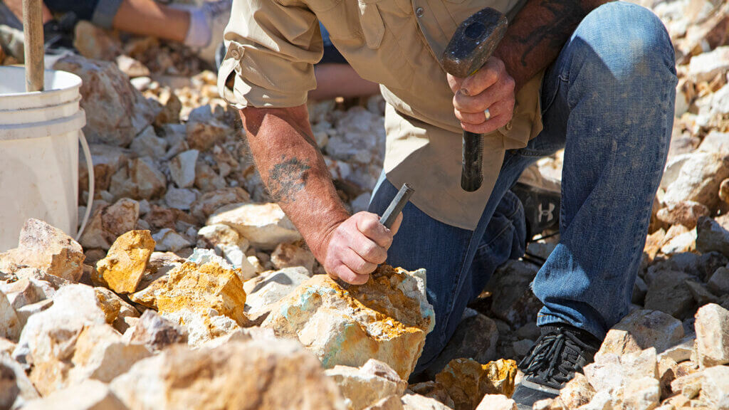 man chiseling on otteson brothers turquoise mine tour