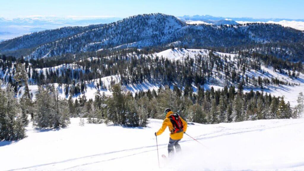 man backcountry skiing from mt rose meadows